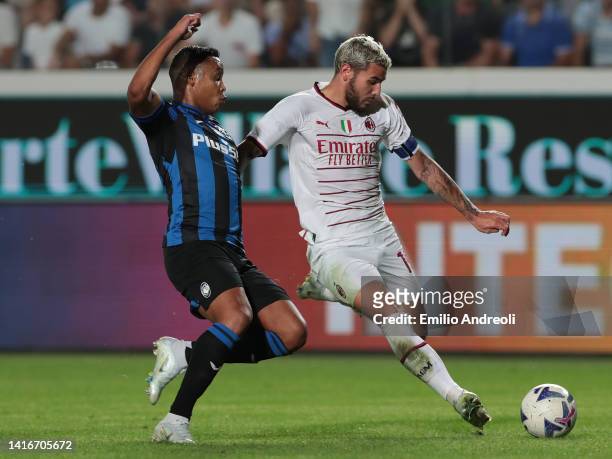 Theo Hernandez of AC Milan is challenged by Luis Muriel of Atalanta BC during the Serie A match between Atalanta BC and AC Milan at Gewiss Stadium on...