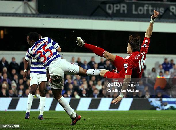 Sebastian Coates of Liverpool scores the first goal during the Barclays Premier League match between Queens Park Rangers and Liverpool at Loftus Road...