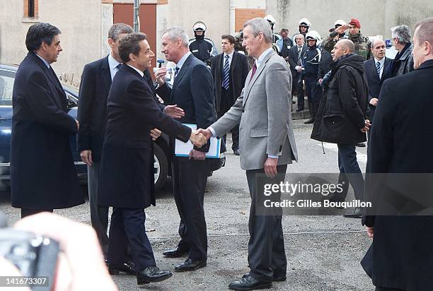 French President Nicolas Sarkozy shakes hand with Toulouse prosecutor Michel Valetas as he arrives to monitor police operations as they continue to...