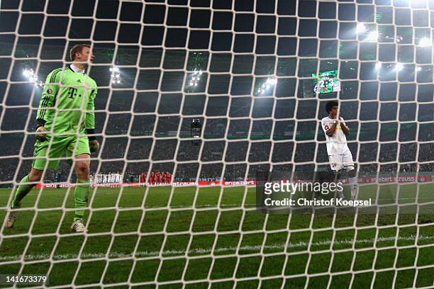 Dante of Moenchengladbach looks dejected after missing a penalty against Manuel Neuer of Bayern during the penalty shoot-out during the DFB Cup semi...