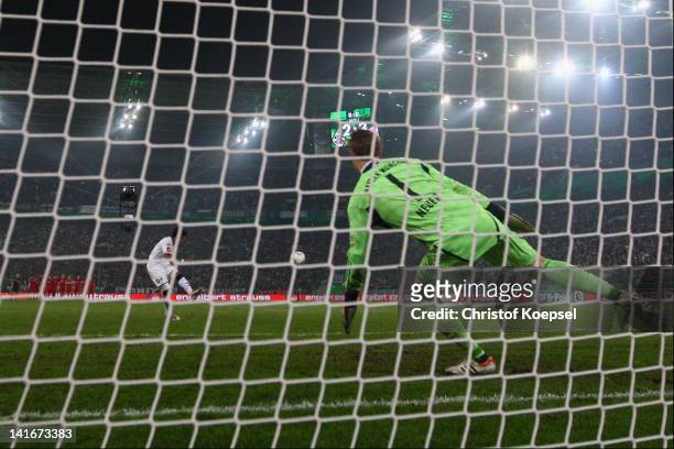 Dante of Moenchengladbach misses a penalty against Manuel Neuer of Bayern during the penalty shoot-out during the DFB Cup semi final match between...