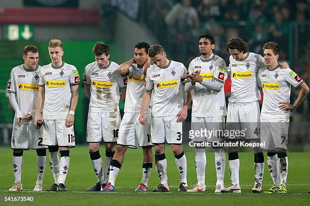 The team of Gladbach looks dejected during the penalty shoot-out after Dante missed scoring a penalty during the DFB Cup semi final match between...