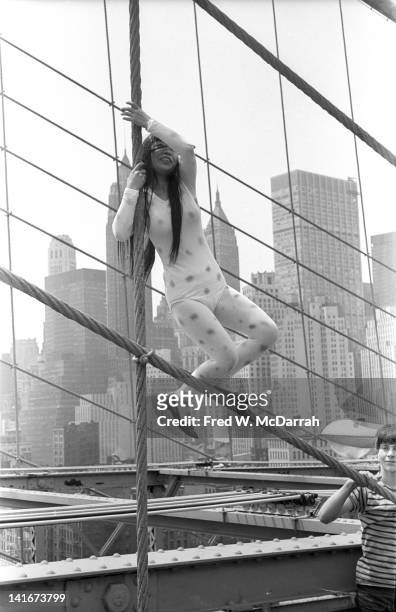 Portrait of Japanese artist Yayoi Kusama as she poses on the Brooklyn Bridge, dressed in polka dots, New York, New York, May 17, 1968.