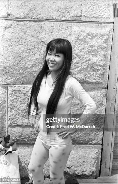 Portrait of Japanese artist Yayoi Kusama as she poses on the Brooklyn Bridge, dressed in polka dots, New York, New York, May 17, 1968.