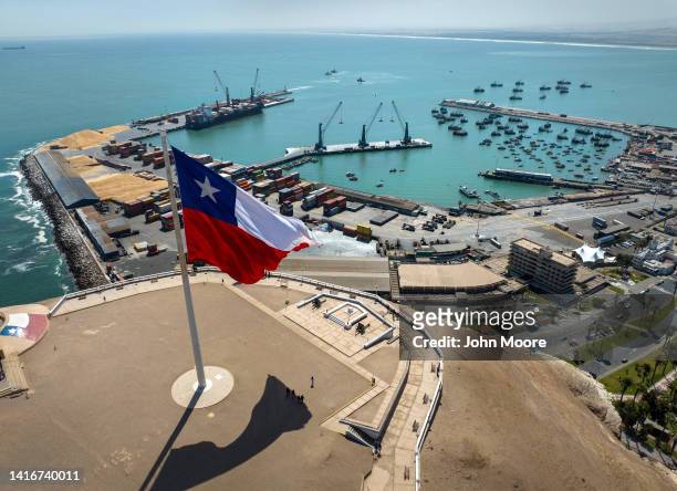 As seen from an aerial view, a Chilean flag flies overlooking the Port of Arica on August 21, 2022 in Arica, northern Chile. Most of the goods that...