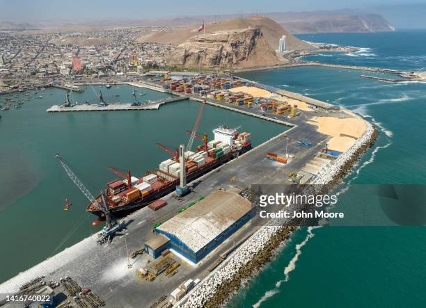 As seen from an aerial view, a container ship is unloaded at the Port of Arica on August 21, 2022 in Arica, northern Chile. Most of the goods that...