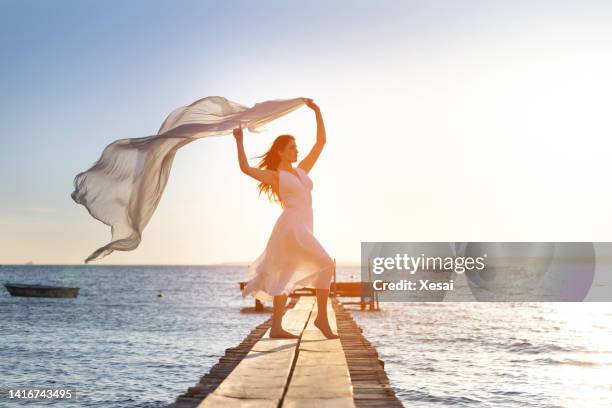 young woman have fun on the beach and feel the freedom alone - curtain blowing stock pictures, royalty-free photos & images