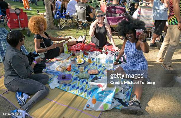 Group of crowd members relaxing at Grand Park's 10th anniversary of Sunday Sessions on August 21, 2022 at Grand Park in Los Angeles, California.