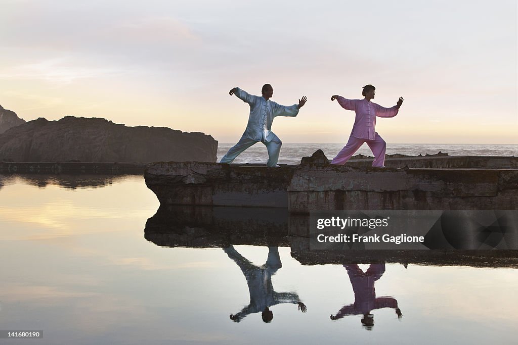 Man and woman practicing Tai Chi.