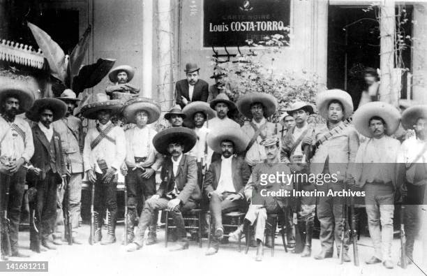 Group portrait showing Mexican revolutionary leader Emiliano Zapata , seated in center, among his men, early twentieth century.