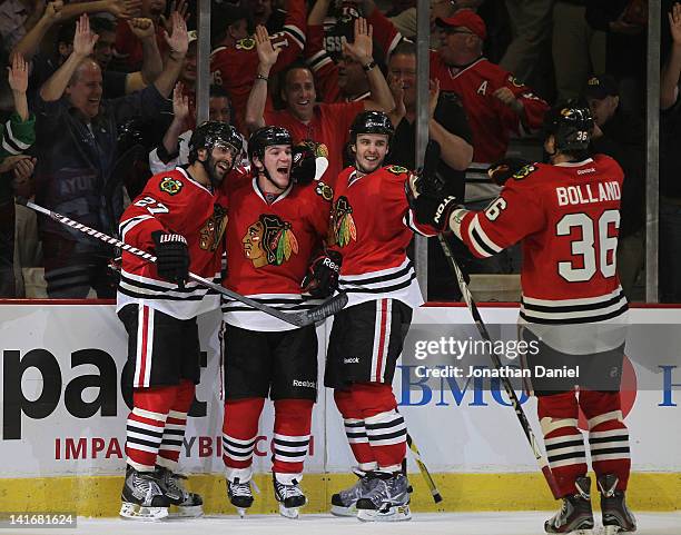 Johnny Oduya, Andrew Shaw, Niklas Hjalmarsson and Dave Bolland celebrate Shaw's winning goal against the Chicago Blackhawks of the Vancouver Canucks...