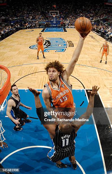 Robin Lopez of the Phoenix Suns goes to the basket against Glen Davis of the Orlando Magic during the game on March 21, 2012 at Amway Center in...