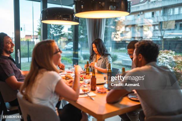 cool people enjoying a relaxing dinner party - summer indoors stock pictures, royalty-free photos & images