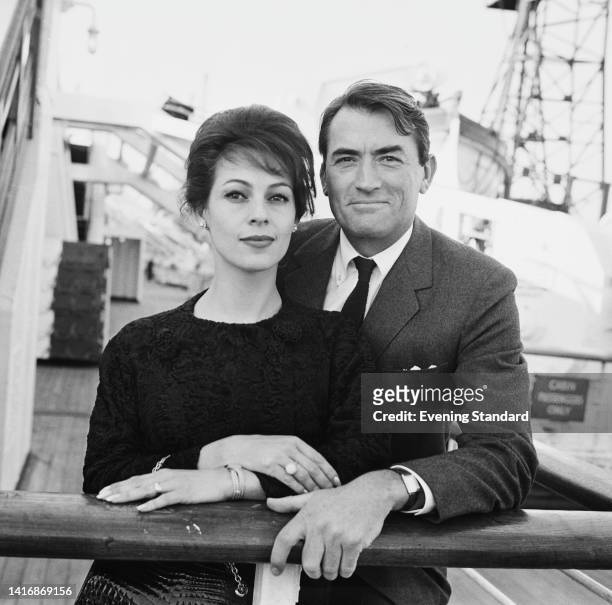 French-American journalist Veronique Peck and her husband, American actor Gregory Peck , stand together by the guardrail of an ships, United Kingdom,...