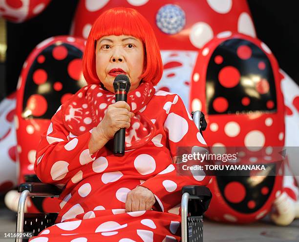 Japanese avant-garde artist Yayoi Kusama answers questions during a press preview for an 32-hour art event at Roppongi shopping district in Tokyo on...