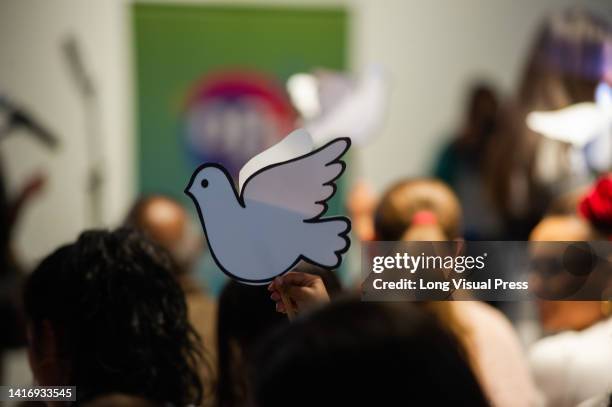 Boy waves a white pigeon of peace during the event of The Children of Peace that are part of Bogota's Philharmonic Orchestra, in Bogota, Colombia,...