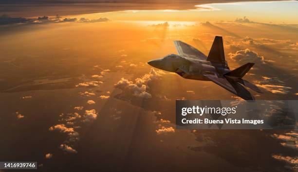 army jet flying over clouds at sunset - supersonic airplane stock pictures, royalty-free photos & images