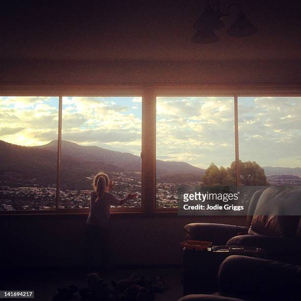 child looking out of window - girl standing stock pictures, royalty-free photos & images