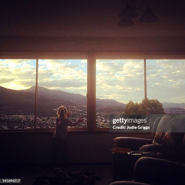 child looking out of window - town square bildbanksfoton och bilder