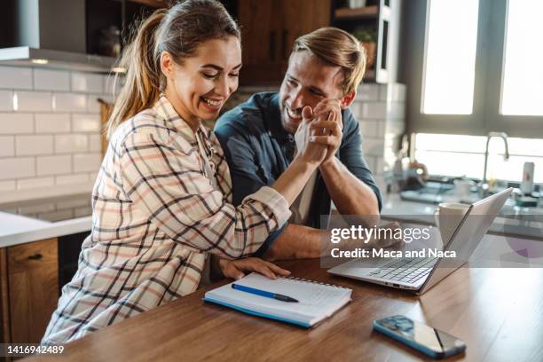 happy family couple giving high- five to each other - couple laptop stock pictures, royalty-free photos & images