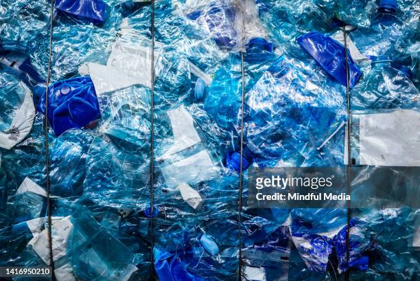 crushed transparent and blue bottles tied up with wire - plastic pollution stock pictures, royalty-free photos & images