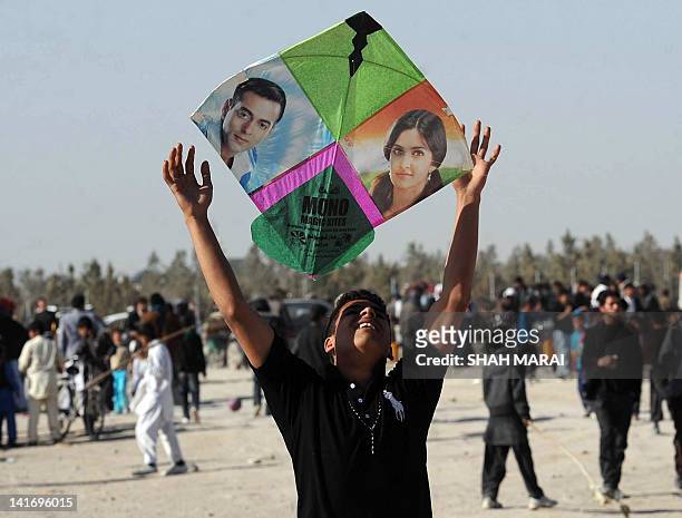 With Afghanistan-social-leisure-NewYear by Joris Fioriti In this picture taken on March 21, 2012 an Afghan teenager prepares to fly his kite adorned...