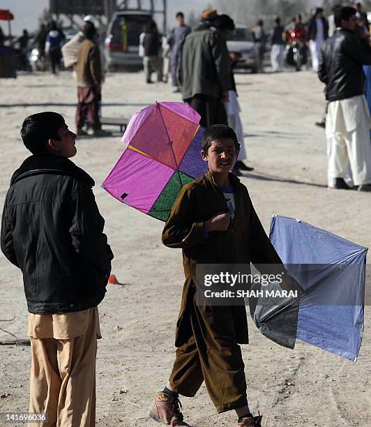 With Afghanistan-social-leisure-NewYear by Joris Fioriti In this picture taken on March 21, 2012 an Afghan teenager holds his kites for sale on a...