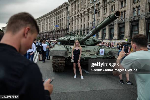 People take photos at the remains of Russian tanks exhibited on August 20, 2022 in Kyiv, Ukraine. On August 24, Ukraine celebrates its 1991...