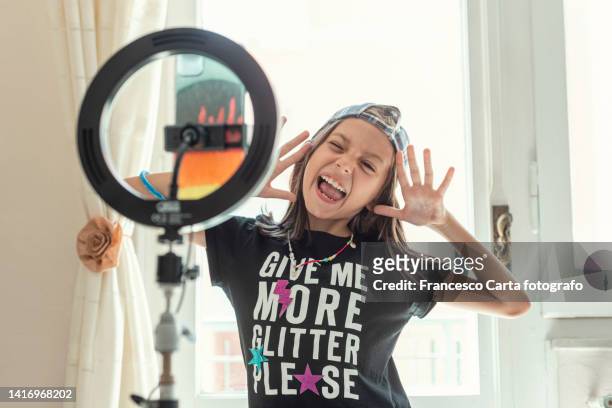 happy teen blogger using smartphone and ring light - child using a smartphone stock pictures, royalty-free photos & images