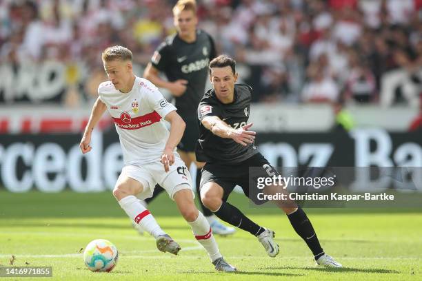 Chris Fuehrich of VfB Stuttgart challenges Nicolas Hoefler of SC Freiburg during the Bundesliga match between VfB Stuttgart and Sport-Club Freiburg...