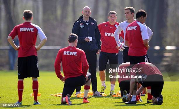 Head coach Stale Solbakken gives instructions to Lukas Podolski, goalkeeper Michael Rensing and other players during a 1. FC Koeln training session...