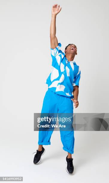 man reaching up - arms raised foto e immagini stock