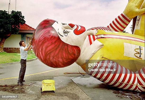 Independent Contractor Luis Elizalde gives Ronald McDonald a good scrubbing and washing of a giant air filled balloon, May 8, 1995 in Long Beach,...