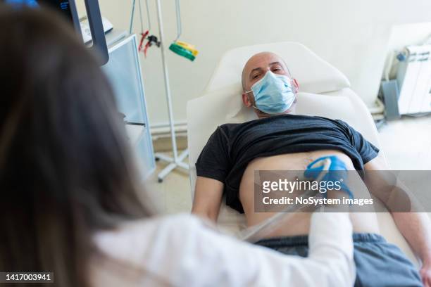 腹部超音波診断 - male stomach ストックフォトと画像