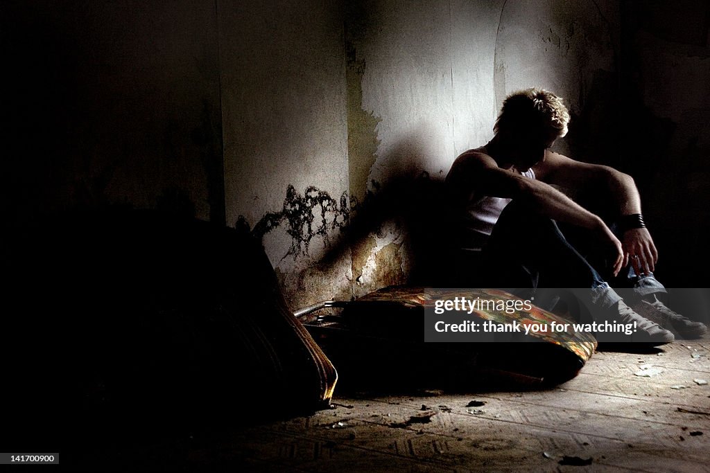 Lonely man sitting in dark room