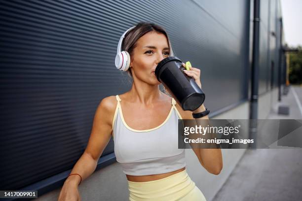 woman drinking water - protein drink stock pictures, royalty-free photos & images
