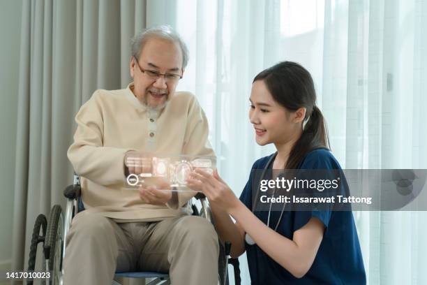 nurse holding ai tablet with medical history for an elderly male. senior male and her designated care giver discussing test results.medical technology concept. remote medicine. electronic medical record. - patient history stock pictures, royalty-free photos & images