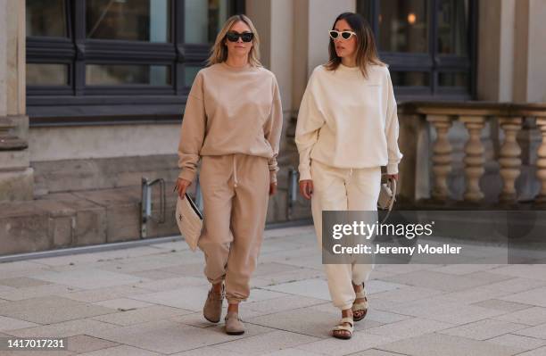 Anne Philine seen wearing black Celine sunglasses, a beige SohoStudios sweater, a beige SohoStudios jogger pants, white Chanel clutch bag and brown...