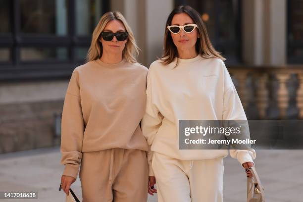 Anne Philine seen wearing black Celine sunglasses, a beige SohoStudios sweater, a beige SohoStudios jogger pants; Elise Seitz seen wearing white...