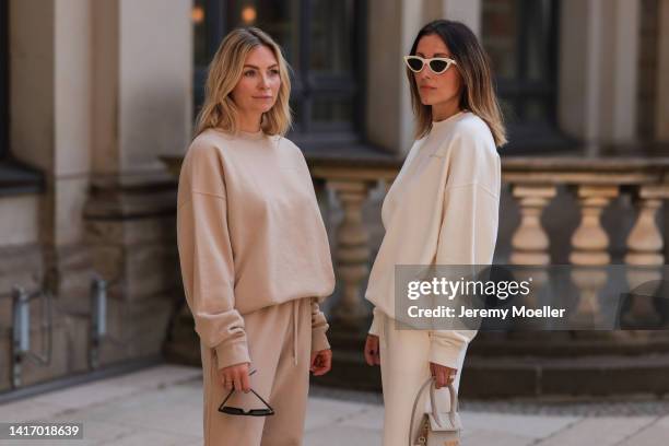 Anne Philine seen wearing black Celine sunglasses, a beige SohoStudios sweater, a beige SohoStudios jogger pants; Elise Seitz seen wearing white...