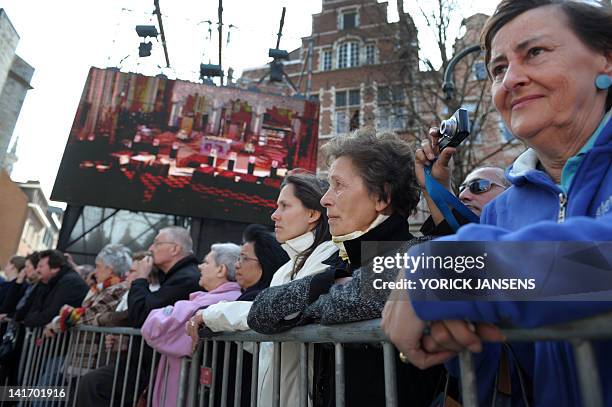 People gather on March 22, 2012 outside the Sint-Pieters church in Leuven during a funeral service for the seven children from Heverlee, who were...