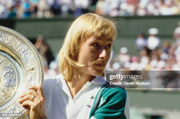 Czech-American tennis player Martina Navratilova holds up a trophy following her victory at Wimbledon, London, England, July 1987.