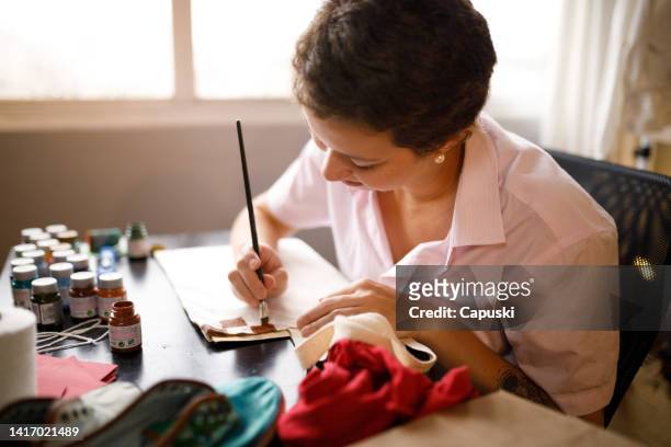 concentrated woman working in a craft project - sustentabilidade stock pictures, royalty-free photos & images