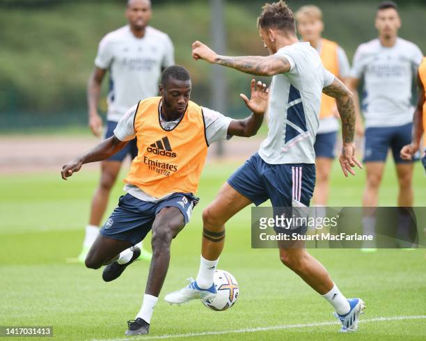 Nicolas Pepe and Ben Whiteof Arsenal during a training session at London Colney on August 22, 2022 in St Albans, England.
