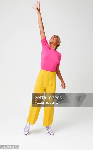 woman reaching up - tiptoe stock pictures, royalty-free photos & images