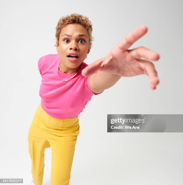 woman reaching hand toward camera - reiken stockfoto's en -beelden