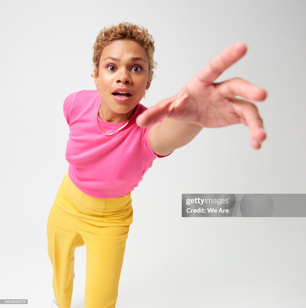 Woman reaching hand toward camera