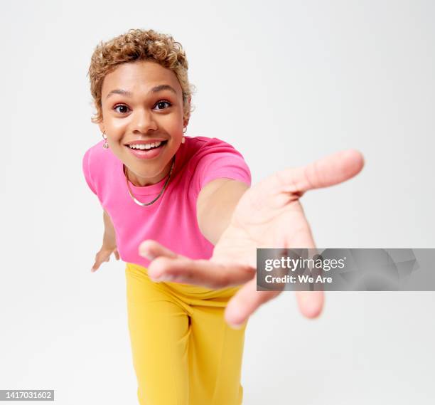 woman reaching hand toward camera - welcome hands stock pictures, royalty-free photos & images