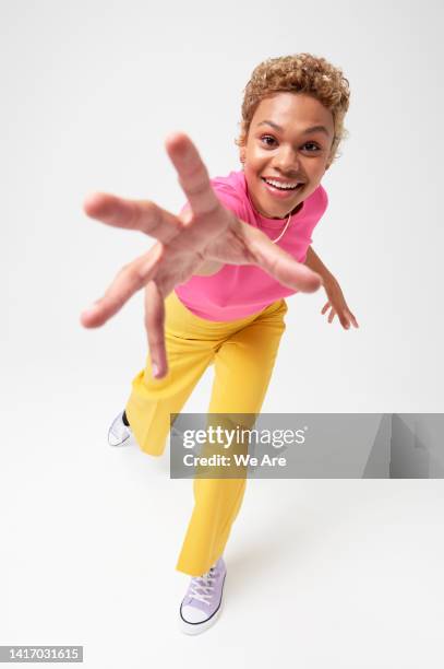 woman reaching hand toward camera - desire foto e immagini stock