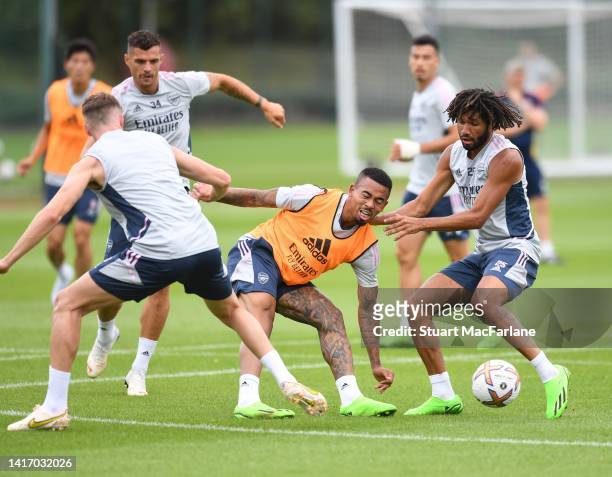 Rob Holding, Gabriel Jesus and Mo Elneny of Arsenal during a training session at London Colney on August 22, 2022 in St Albans, England.